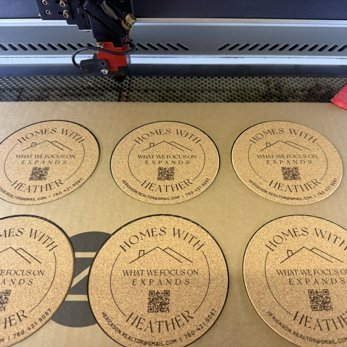 A batch of cork coasters being laser engraved in the YJune Studio.